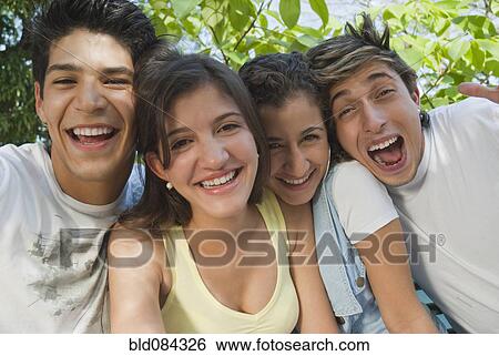 Stock Photograph - Laughing Hispanic friends. Fotosearch