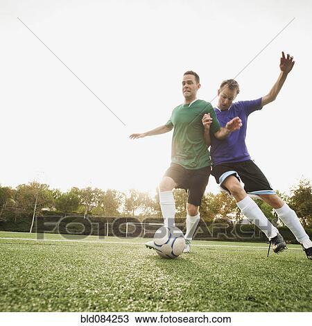 Men playing soccer on soccer field View Large Photo Image Stock Image - Men playing soccer on soccer field. Fotosearch