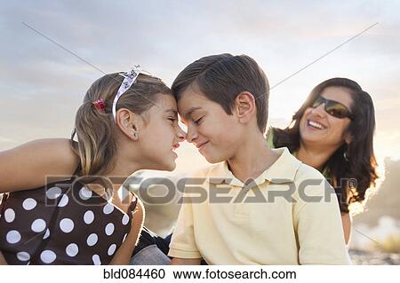 Stock Image - Mixed race brother and sister playing outdoors. Fotosearch