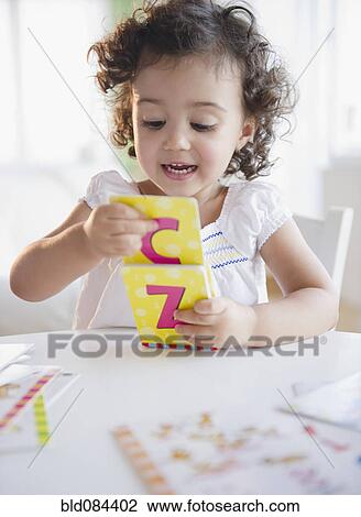 Mixed race girl playing with alphabet cards View Large Photo Image Stock Image - Mixed race girl playing with alphabet cards. Fotosearch