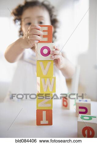 Mixed race girl stacking blocks View Large Photo Image Stock Photograph - Mixed race girl stacking blocks. Fotosearch