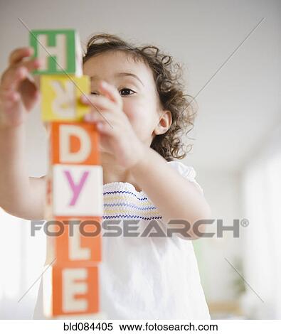 Stock Photography - Mixed race girl stacking blocks. Fotosearch
