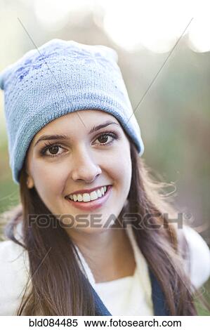 Stock Photography - Mixed race woman in cap outdoors. Fotosearch