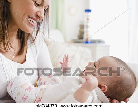 Stock Image - Mother smiling at baby. Fotosearch
