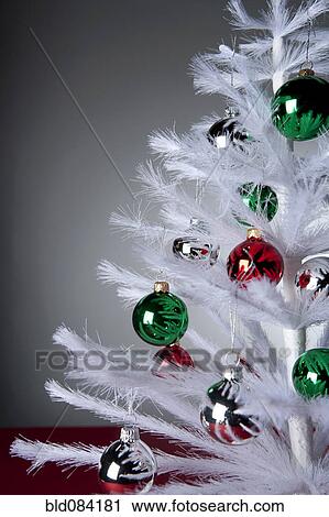 Ornaments on white, artificial Christmas tree View Large Photo Image Stock Image - Ornaments on white, artificial Christmas tree. Fotosearch