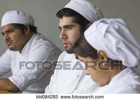 Serious bakers in chef's whites View Large Photo Image Stock Image - Serious bakers in chef's whites. Fotosearch