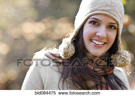 Stock Photography - Smiling mixed race woman in cap. Fotosearch