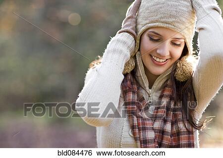 Stock Photograph - Smiling mixed race woman with arms raised. Fotosearch