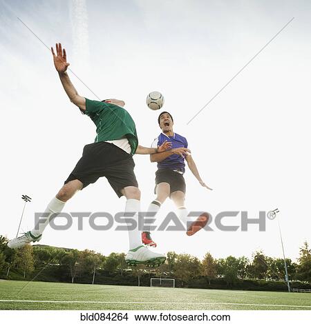 Picture - Soccer players heading soccer ball. Fotosearch