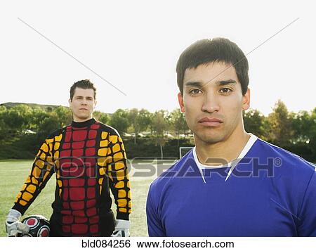 Stock Photograph - Soccer players standing on soccer field. Fotosearch