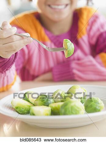African American girl eating Brussels sprouts View Large Photo Image Stock Image - African American girl eating Brussels sprouts. Fotosearch