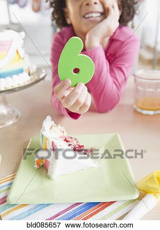 African American girl holding the number 6 at birthday party View Large Photo Image Stock Photo - African American girl holding the number 6 at birthday party. Fotosearch