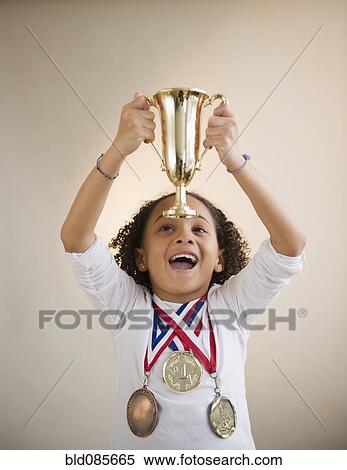 African American girl holding up trophy View Large Photo Image Stock Photography - African American girl holding up trophy. Fotosearch