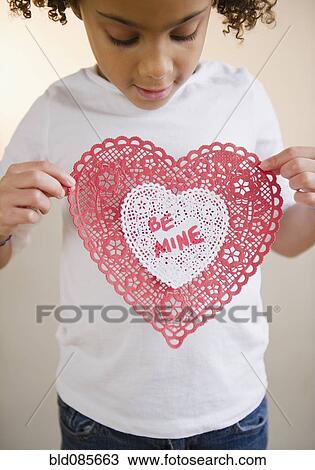 Stock Image - African American girl holding Valentine. Fotosearch