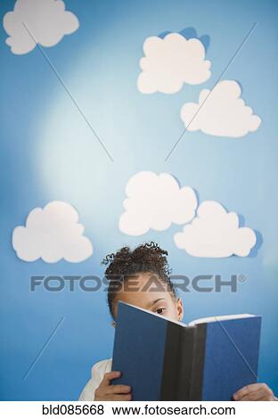 Stock Photo - African American girl reading book. Fotosearch
