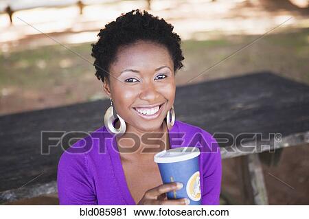Stock Image - African American woman drinking coffee. Fotosearch