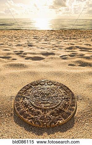 Aztec calendar stone carving on sandy beach View Large Photo Image Stock Photography - Aztec calendar stone carving on sandy beach. Fotosearch
