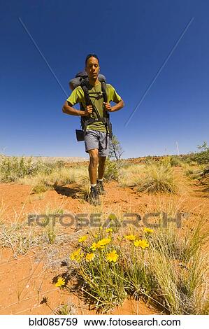 Stock Photo - Black man hiking in desert. Fotosearch