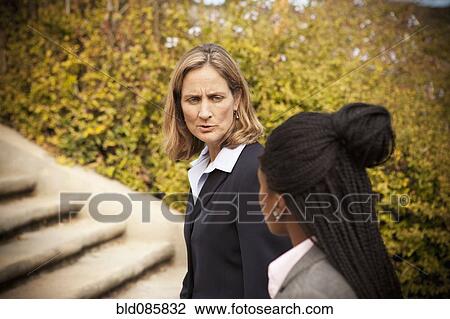 Businesswomen walking together outdoors View Large Photo Image Stock Image - Businesswomen walking together outdoors. Fotosearch