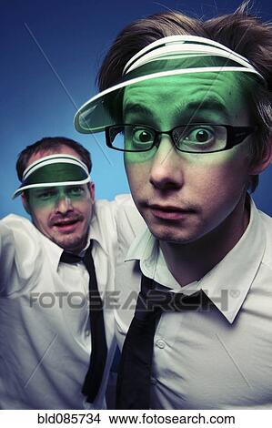 Caucasian businessmen wearing poker visors View Large Photo Image Picture - Caucasian businessmen wearing poker visors. Fotosearch