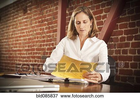 Stock Photo - Caucasian businesswoman working in office. Fotosearch