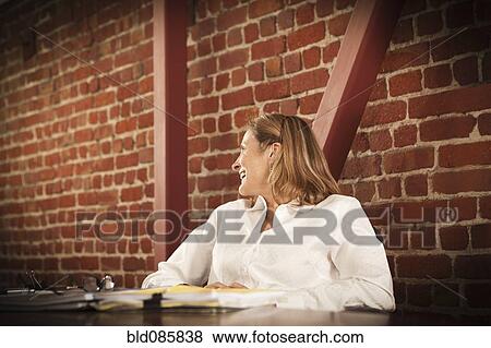 Stock Photo - Caucasian businesswoman working in office. Fotosearch