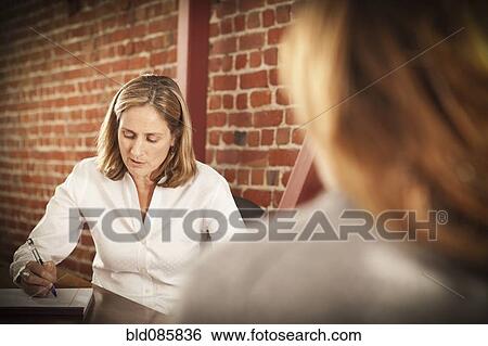 Stock Photograph - Caucasian businesswoman working in office. Fotosearch