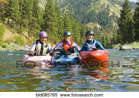 Caucasian girls kayaking in river View Large Photo Image Stock Photography - Caucasian girls kayaking in river. Fotosearch