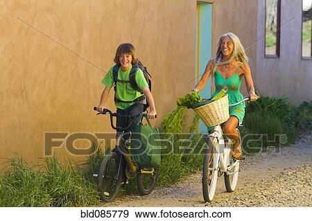 Stock Photo - Caucasian grandmother and grandson riding bicycles. Fotosearch