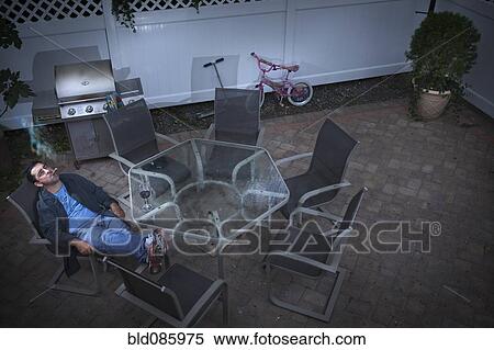 Caucasian man drinking wine and smoking on patio View Large Photo Image Stock Photography - Caucasian man drinking wine and smoking on patio. Fotosearch