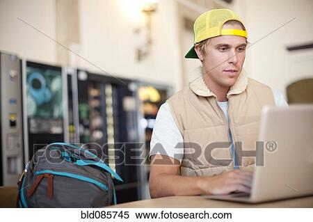 Caucasian man using laptop in train station View Large Photo Image Stock Photography - Caucasian man using laptop in train station. Fotosearch