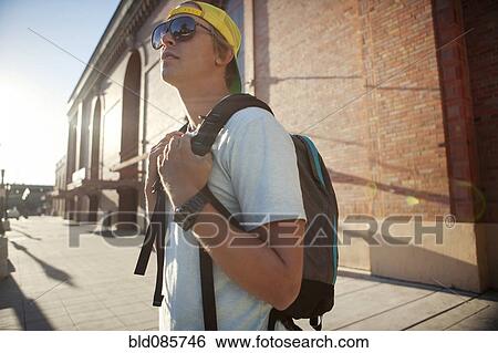 Caucasian man wearing sunglasses and backpack View Large Photo Image Stock Photograph - Caucasian man wearing sunglasses and backpack. Fotosearch