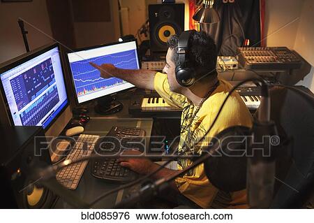 Caucasian man working in music studio View Large Photo Image Stock Photograph - Caucasian man working in music studio. Fotosearch