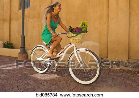 Caucasian woman riding bicycle View Large Photo Image Picture - Caucasian woman riding bicycle. Fotosearch