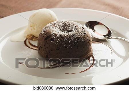 Stock Image - Chocolate cake and ice cream on plate. Fotosearch