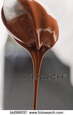 Chocolate dripping from spoon View Large Photo Image Stock Photo - Chocolate dripping from spoon. Fotosearch