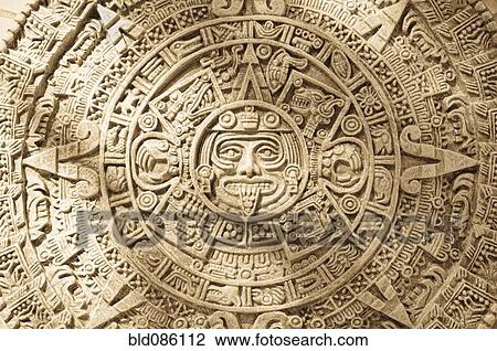 Stock Image - Close up of Aztec calendar stone carving. Fotosearch