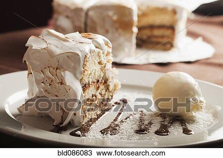 Stock Image - Close up of cake and ice cream on plate. Fotosearch