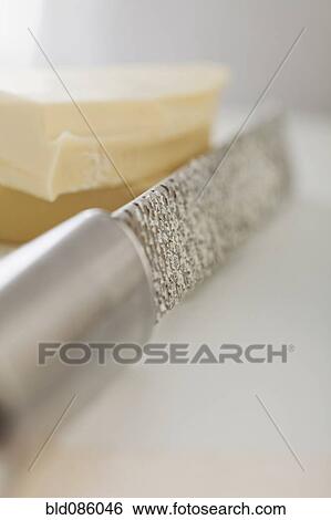 Close up of cheese and grater View Large Photo Image Stock Photograph - Close up of cheese and grater. Fotosearch