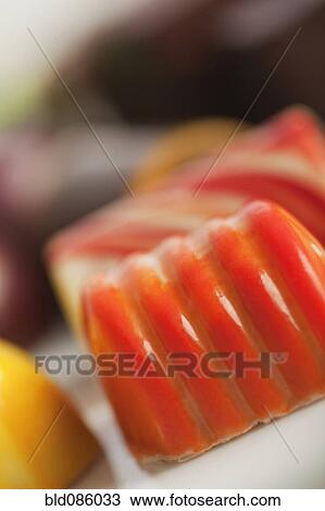 Stock Image - Close up of orange candy. Fotosearch