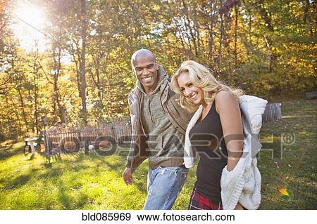 Couple walking in park in autumn View Large Photo Image Stock Photo - Couple walking in park in autumn. Fotosearch