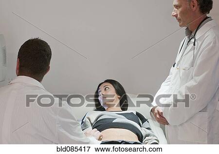 Doctors examining pregnant woman View Large Photo Image Stock Photo - Doctors examining pregnant woman. Fotosearch