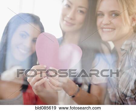 Stock Photo - Friends holding valentine. Fotosearch