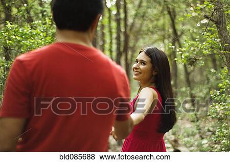 Hispanic couple holding hands and walking outdoors View Large Photo Image Stock Photo - Hispanic couple holding hands and walking outdoors. Fotosearch