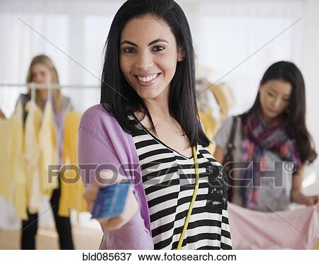 Hispanic woman handing over credit card in store View Large Photo Image Stock Photo - Hispanic woman handing over credit card in store. Fotosearch