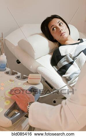 Stock Photograph - Hispanic woman having sonogram examination. Fotosearch