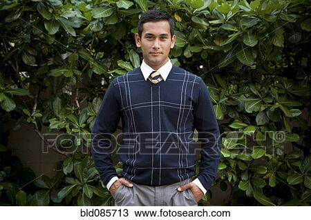 Mixed race businessman standing with hands in pockets View Large Photo Image Stock Image - Mixed race businessman standing with hands in pockets. Fotosearch
