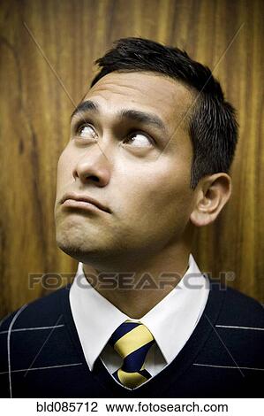 Stock Image - Mixed race businessman thinking. Fotosearch