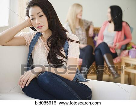 Sad woman isolated from friends View Large Photo Image Stock Photograph - Sad woman isolated from friends. Fotosearch