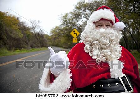 Santa hitchhiking at roadside View Large Photo Image Stock Image - Santa hitchhiking at roadside. Fotosearch
